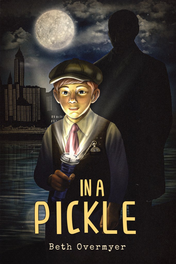 The cover of IN A PICKLE by Beth Overmyer. Charlie Pickle (the protagonist and hero of our story) stands in the moonlight at a pier by water and the 1910s Chicago skyline. He shines a flashlight in his face, and behind him is a shadowy figure we cannot entirely make out.